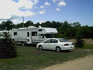 Our rental car with the RV in Sandy Ponds Campground